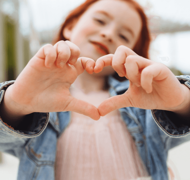 Girl making a heart with her hands